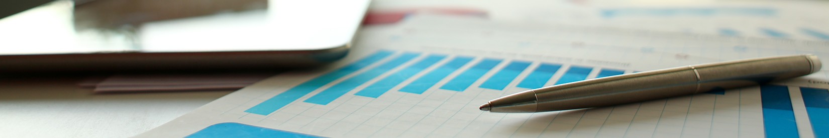 Silver pen lie at important paper on table in empty office closeup.