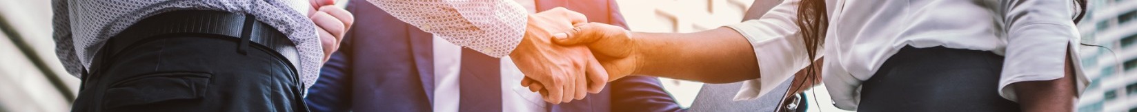 Handshake of business people in a city setting.